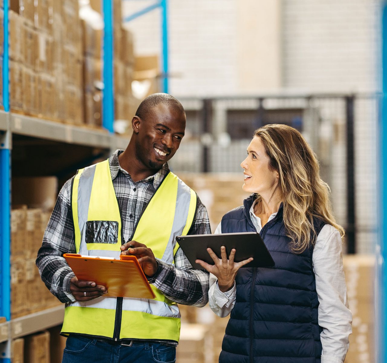 Co-workers collaborating in a warehouse